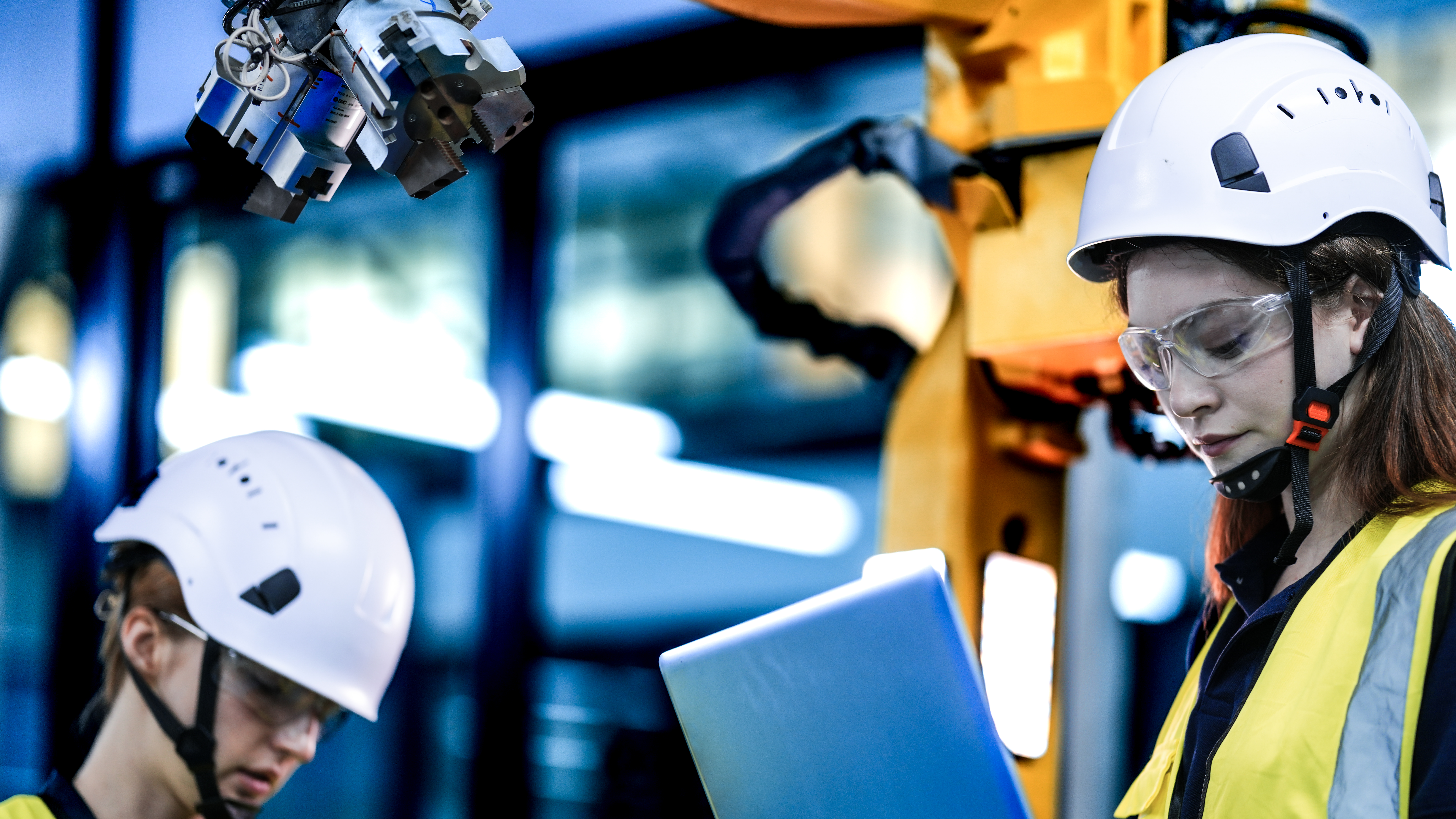 Engineers working with AI and robotics in a factory